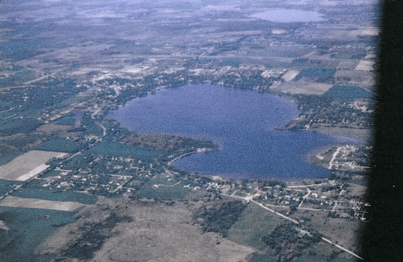 A historical photo of an aerial view of a lake. 