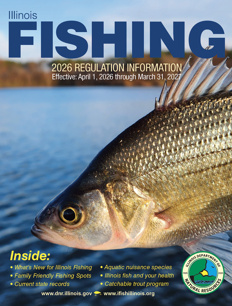 The cover of the Illinois Fishing 2026 Regulation Information booklet. On the cover is a close-up of a tan fish. In the background is a lake with a tree-filled shoreline on the horizon.