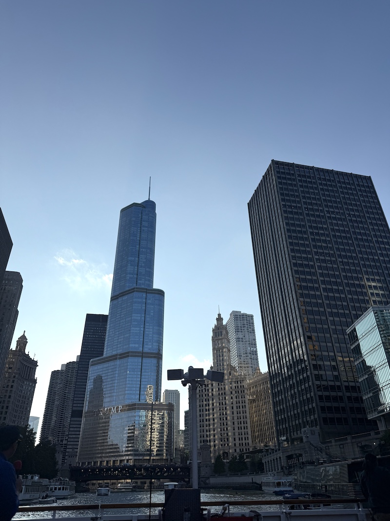 Skyscrapers soar above the Chicago River in Downtown Chicago. A clear blue sky is overhead.