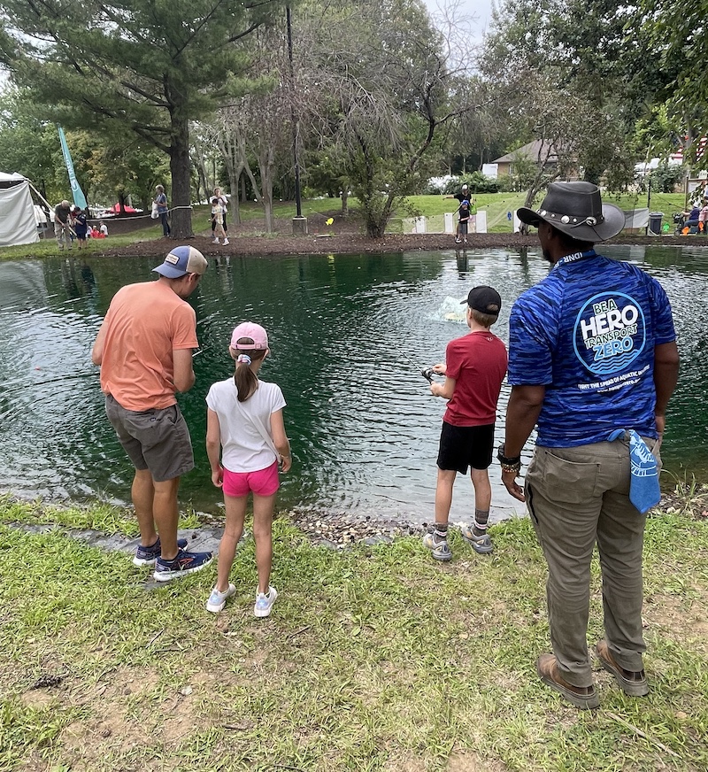 A father and his two children attend a fishing clinic run by the IDNR Urban and Community Fishing Program.
