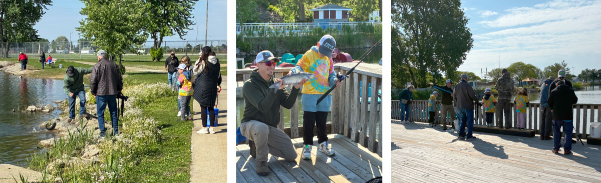 A collage of three photos lined up in a row. The photo to the left is of many people fishing along a shoreline of a pond. One man is helping a young boy pull in a catfish. A sidewalk runs parallel to the shoreline. In the background are a few trees against a bright blue sky. The photo in the middle is of a man holding up a black and gray catfish next to a boy. The boy touches the side of the catfish and smiles from under his ball cap. The boy holds a fishing rod and reel in his left hand. The man and boy are standing on a wooden pier overlooking a pond. The photo on the right is of several people fishing from a wooden pier overlooking a pond. A bright partly cloudy sky is above the pond.